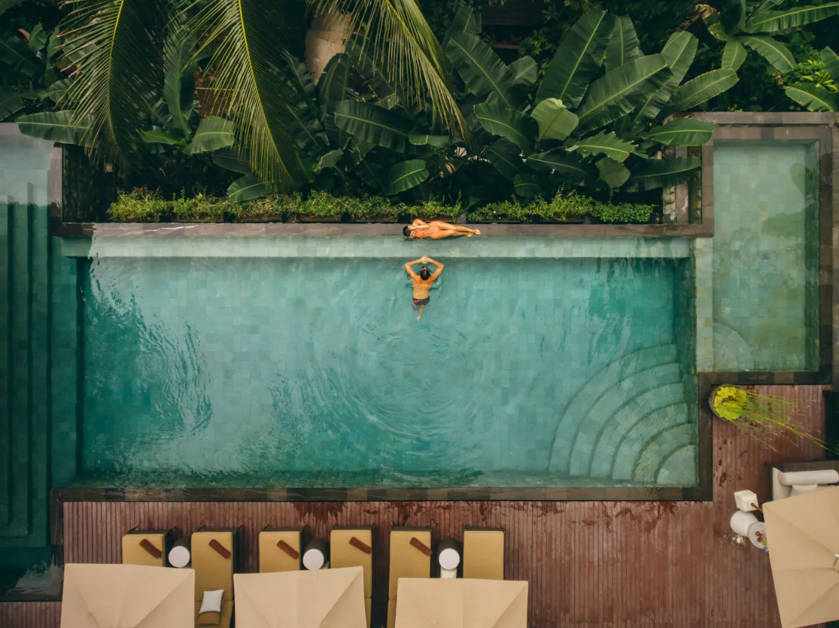 Aerial view of a fully tiled swimming pool in deep green mosaic tile